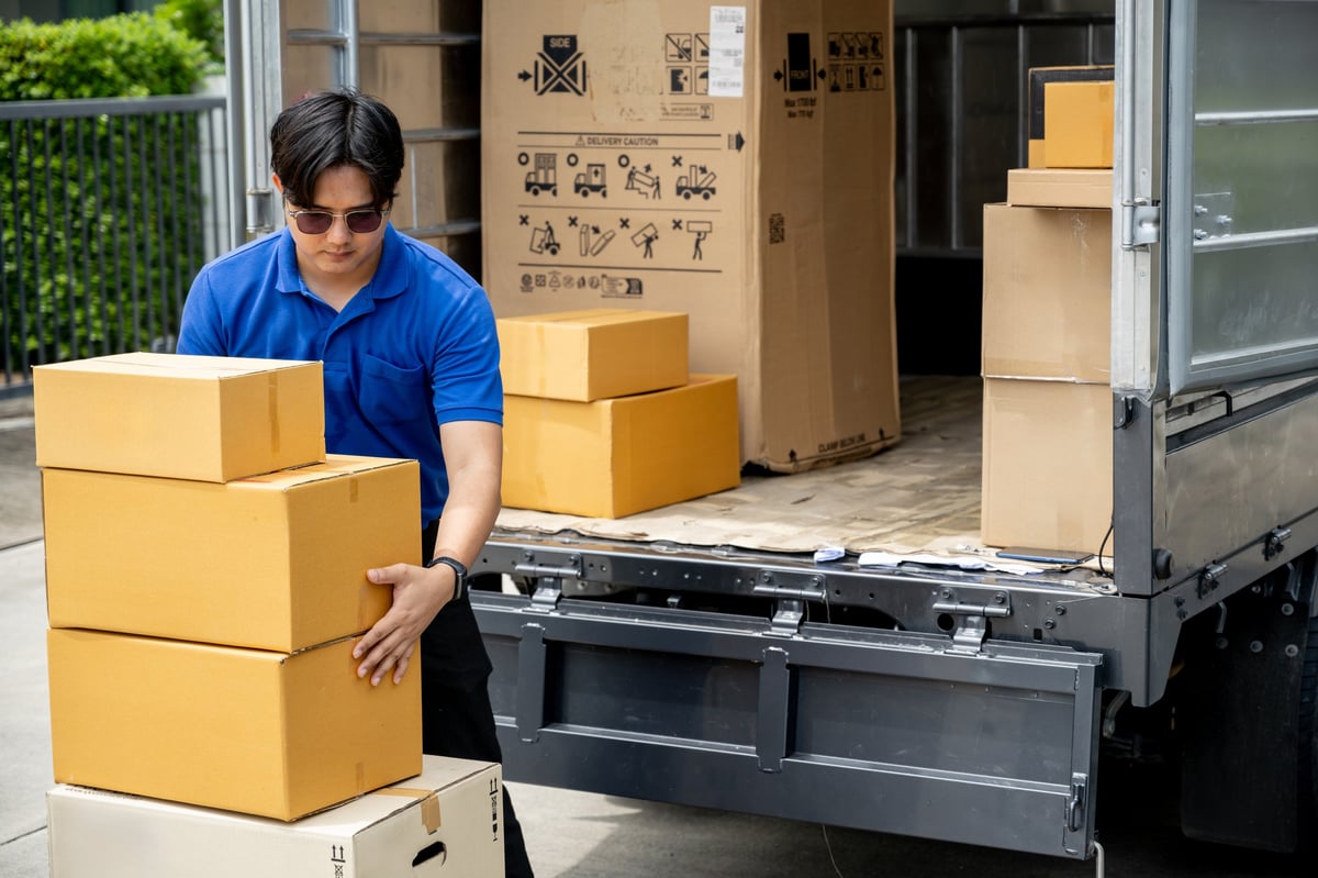 Delivery operator unloading parcels